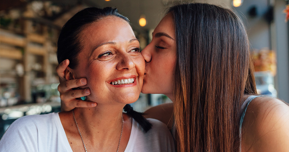 daughter kissing mother