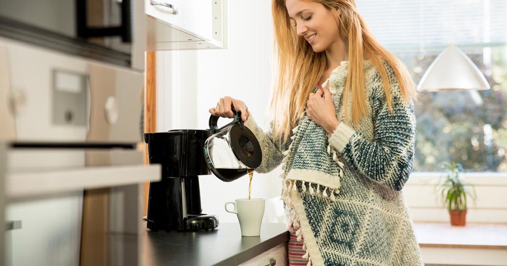 woman at coffee maker