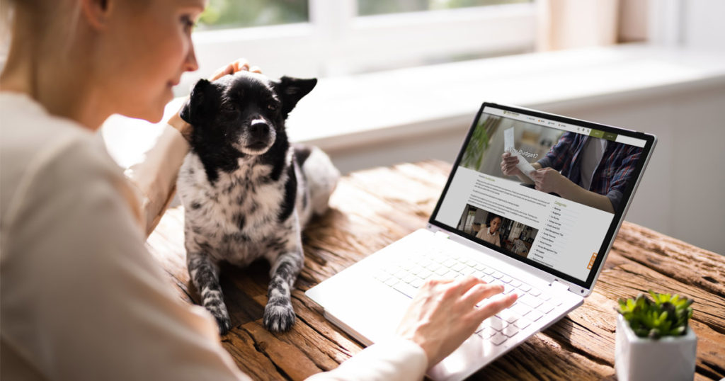 woman at laptop with dog